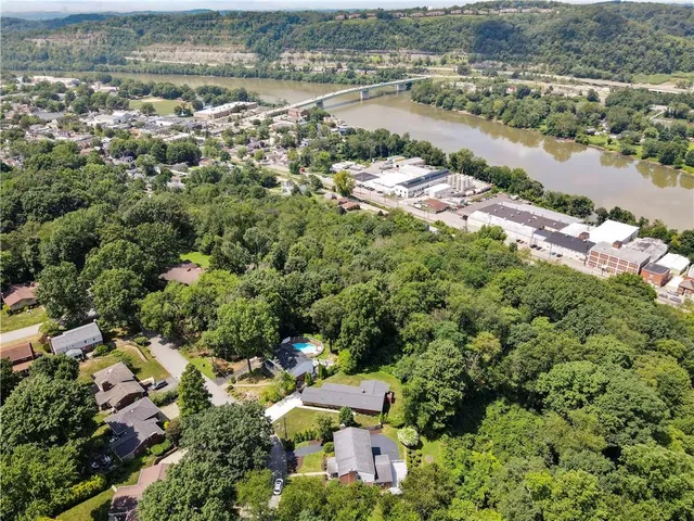 an aerial view of residential houses with outdoor space and river