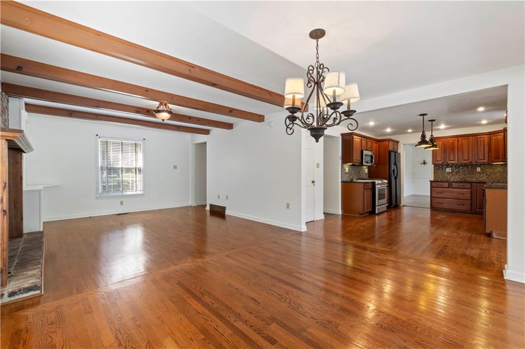 24 Oakglen Drive Oakmont, PA 15139 - Photo 7 of 50 a view of a living room with chandelier and wooden floor