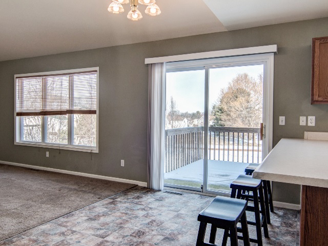 306 Rochester Road Northeast Poplar Grove, IL 61065 - Photo 13 of 25 a view of a room with furniture large windows and wooden floor