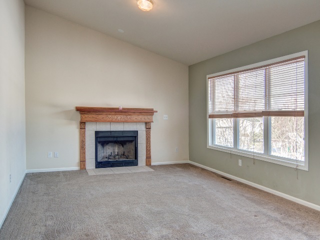 306 Rochester Road Northeast Poplar Grove, IL 61065 - Photo 17 of 25 a view of an empty room with a window and fireplace