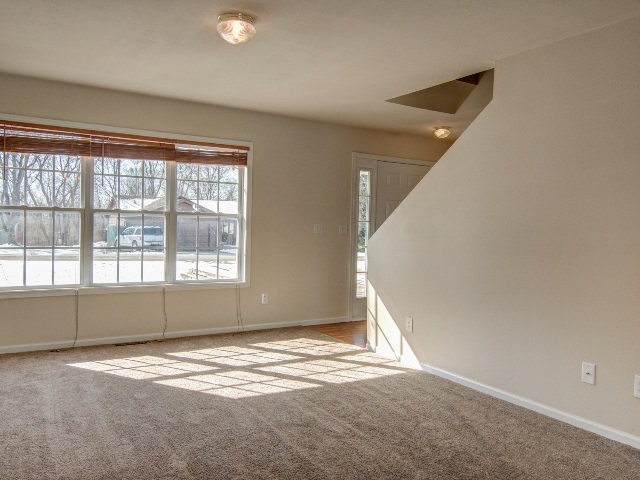 306 Rochester Road Northeast Poplar Grove, IL 61065 - Photo 6 of 25 an empty room with a empty space and windows