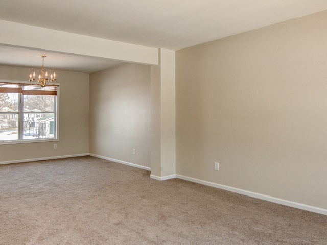 306 Rochester Road Northeast Poplar Grove, IL 61065 - Photo 7 of 25 an empty room with windows and chandelier