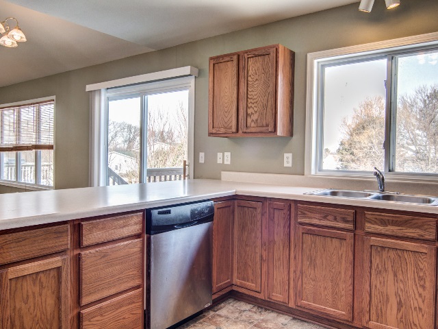 306 Rochester Road Northeast Poplar Grove, IL 61065 - Photo 9 of 25 a kitchen with stainless steel appliances granite countertop a sink and a window