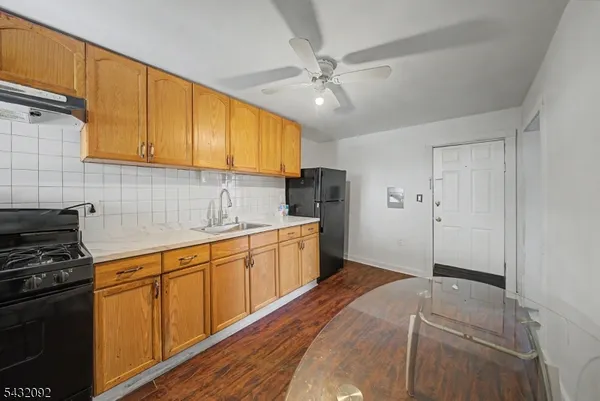 a kitchen with a refrigerator a sink and cabinets