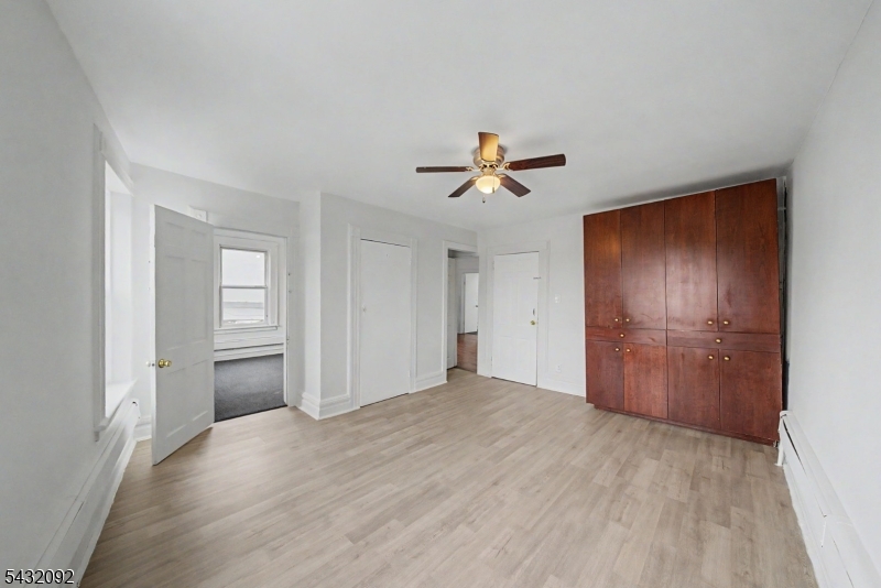309 Main Street, Unit 3 Boonton, NJ 07005 - Photo 4 of 17 a view of empty room with wooden floor and ceiling fan