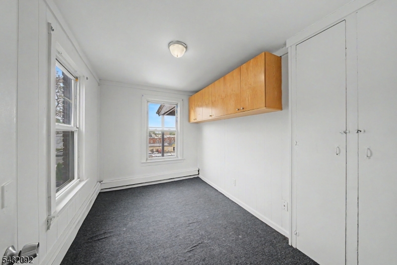 309 Main Street, Unit 3 Boonton, NJ 07005 - Photo 7 of 17 a view of a livingroom with wooden floor and a window