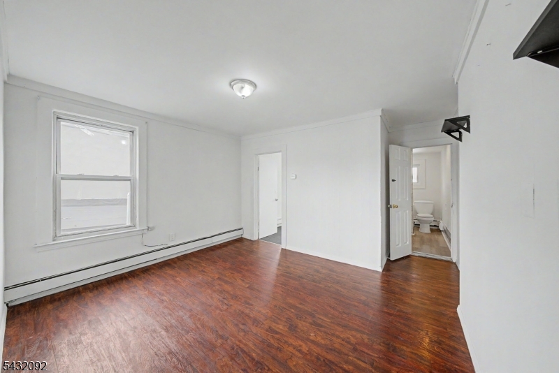 309 Main Street, Unit 3 Boonton, NJ 07005 - Photo 10 of 17 an empty room with wooden floor and windows
