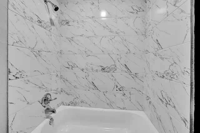 a bathroom with a bathtub and shower