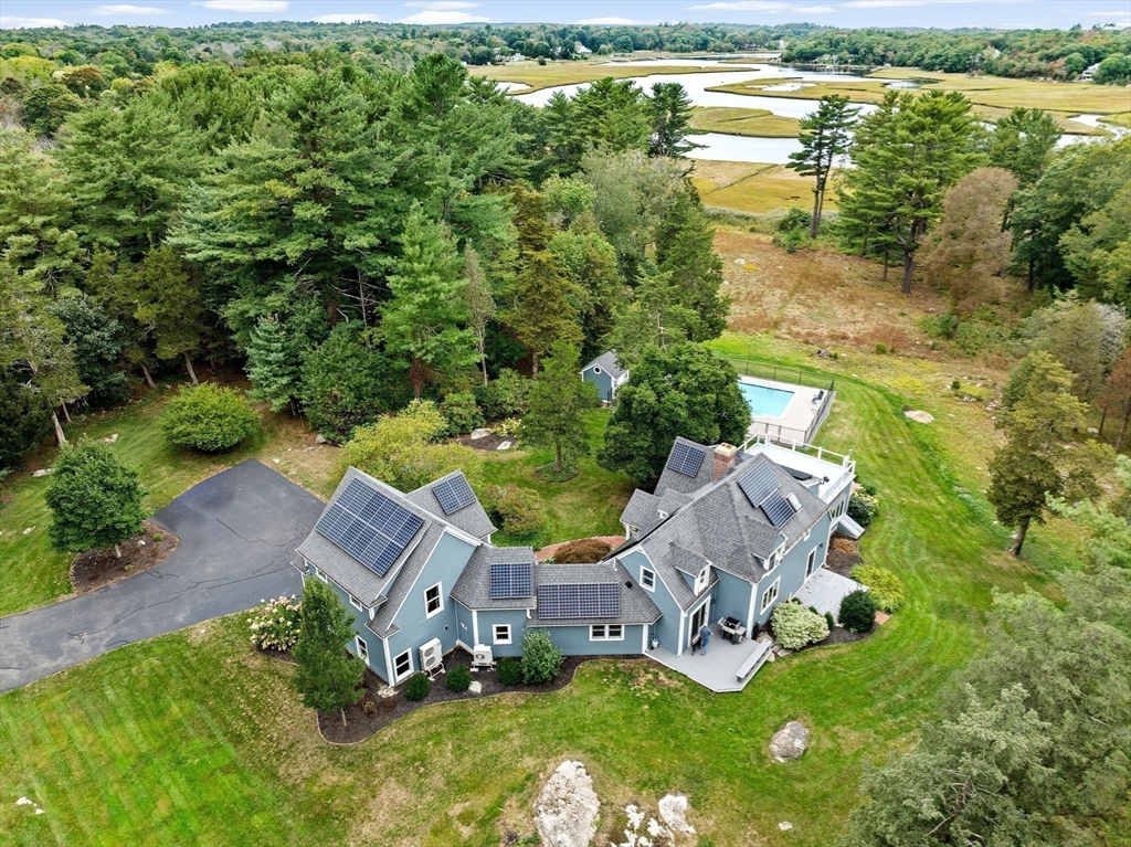 an aerial view of a house with garden space and lake view
