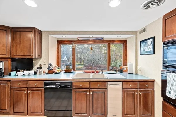 a kitchen with a sink stove and cabinets