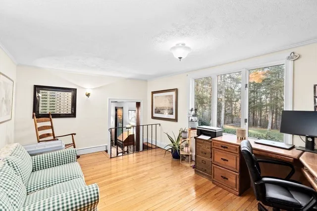 a bedroom with a bed a large window and a chandelier