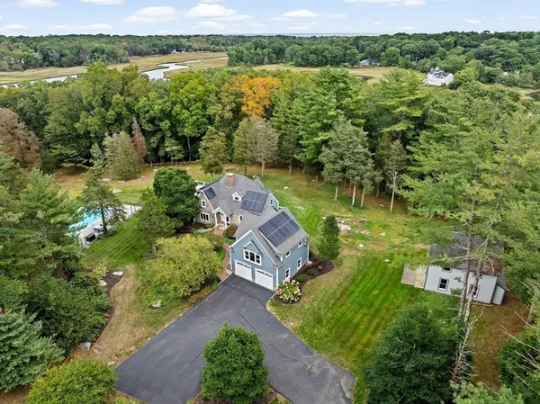 an aerial view of a house with a yard and lake view