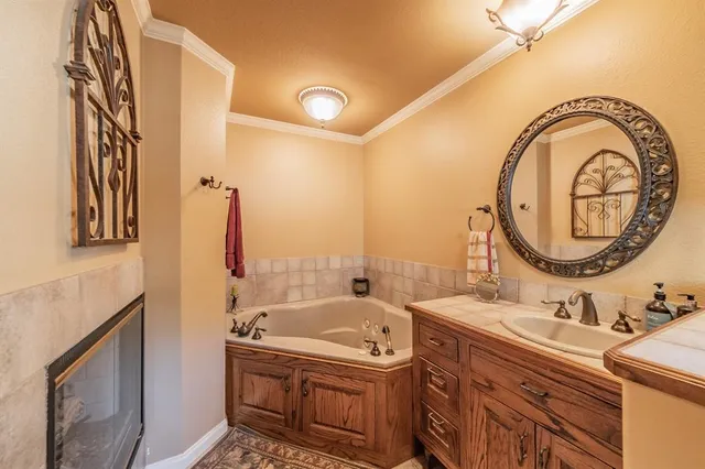a bathroom with a tub sink and mirror