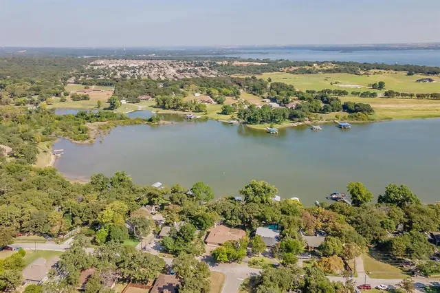 an aerial view of a house with a yard