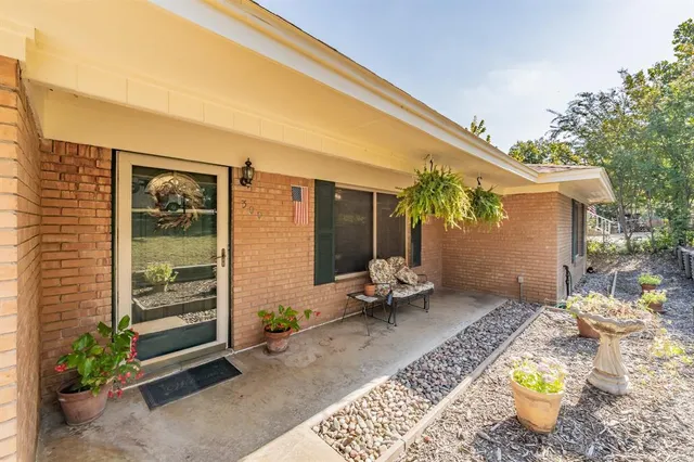a backyard of a house with outdoor seating