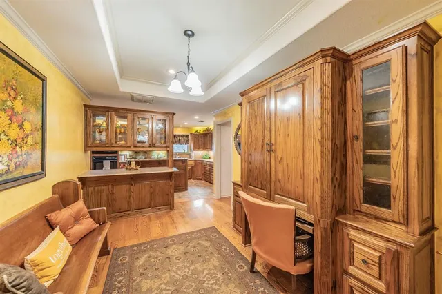 a spacious bedroom with a bed a dresser and large windows