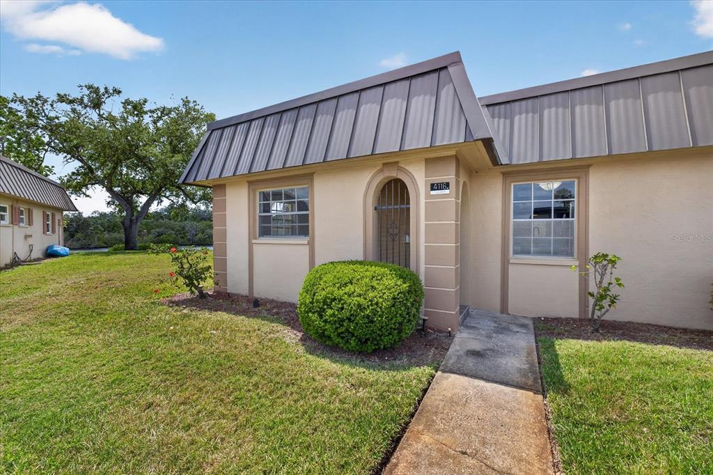 4116 Hampton Drive New Port Richey, FL 34652 - Photo 1 of 35 a front view of a house with garden