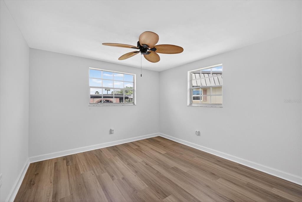 4116 Hampton Drive New Port Richey, FL 34652 - Photo 15 of 35 a view of a room with wooden floor and white walls