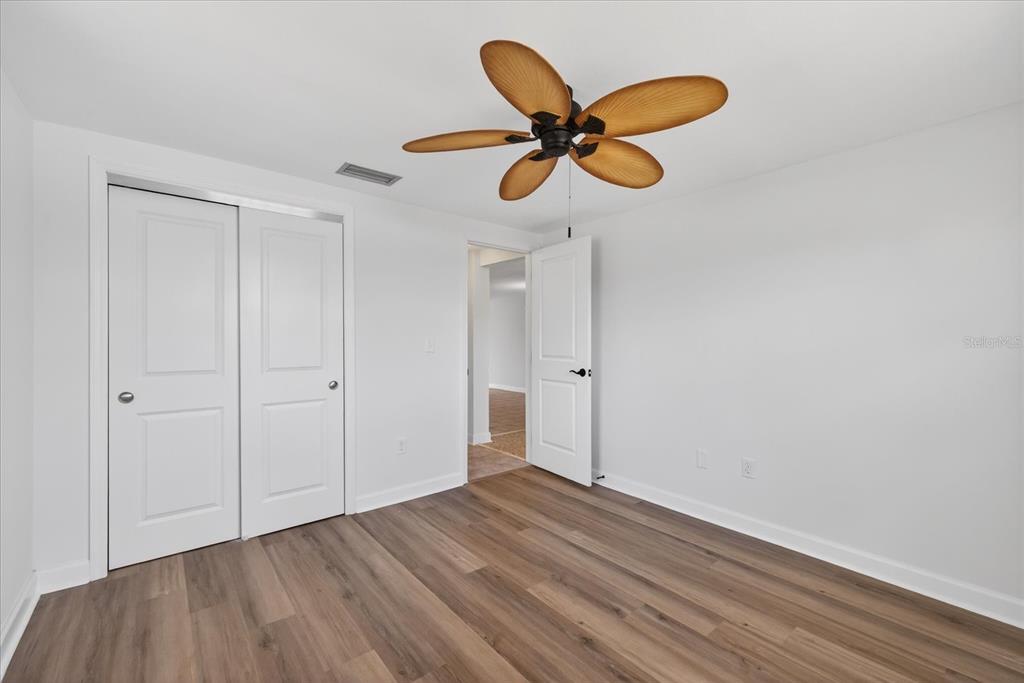 4116 Hampton Drive New Port Richey, FL 34652 - Photo 16 of 35 a view of an empty room and wooden floor