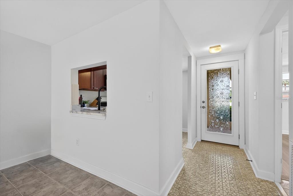 4116 Hampton Drive New Port Richey, FL 34652 - Photo 19 of 35 a view of a hallway with wooden floor and a bathroom