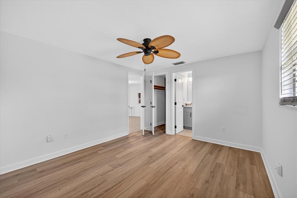 4116 Hampton Drive New Port Richey, FL 34652 - Photo 23 of 35 wooden floor in an empty room with a window