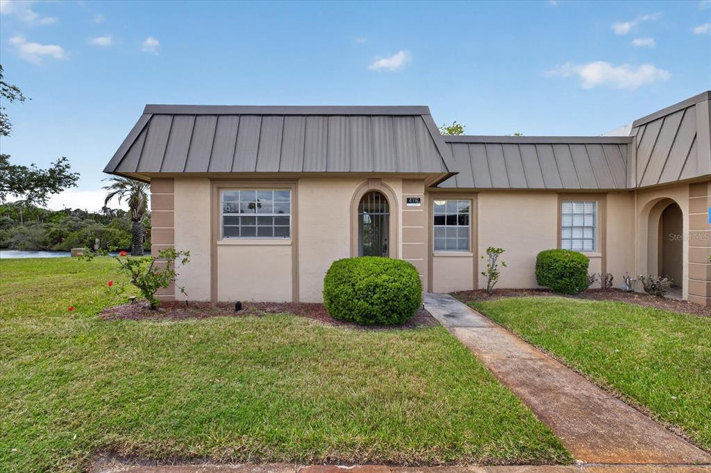 4116 Hampton Drive New Port Richey, FL 34652 - Photo 32 of 35 a front view of a house with a yard and garage