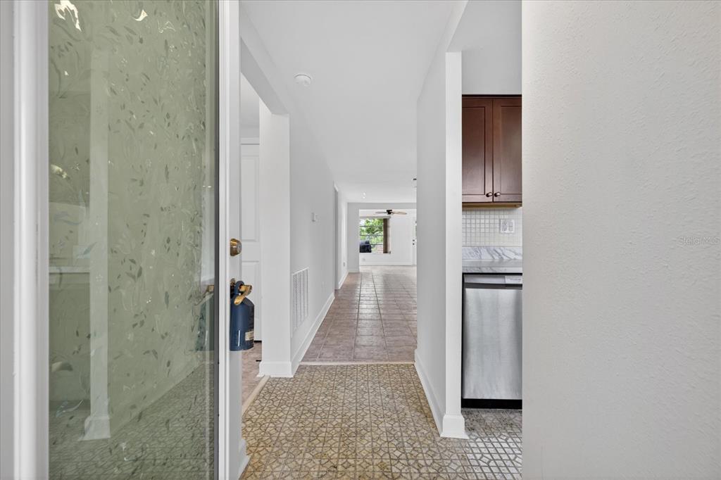 4116 Hampton Drive New Port Richey, FL 34652 - Photo 7 of 35 a view of a hallway with wooden floor and staircase