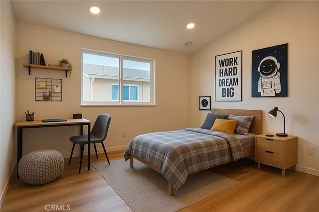 a bedroom with a bed and a desk