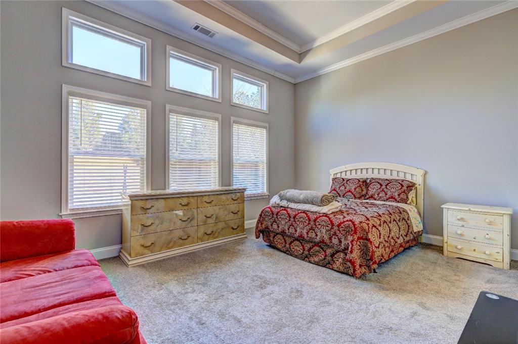 4371 Thacker Lane Suwanee, GA 30024 - Photo 12 of 52 a bedroom with a bed and a window