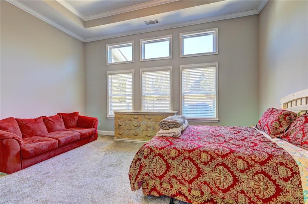 4371 Thacker Lane Suwanee, GA 30024 - Photo 13 of 52 a bedroom with a bed couch and two large window