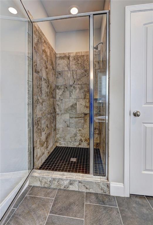 4371 Thacker Lane Suwanee, GA 30024 - Photo 17 of 52 a bathroom with a sink and a shower