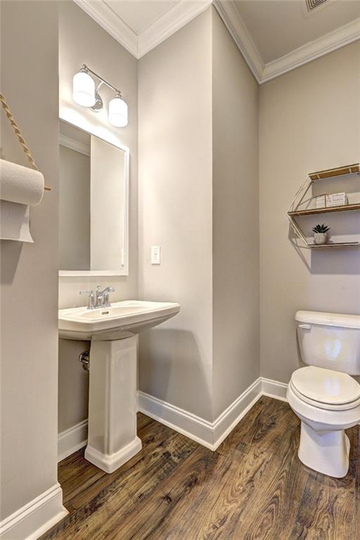 4371 Thacker Lane Suwanee, GA 30024 - Photo 18 of 52 a bathroom with a sink toilet and a mirror