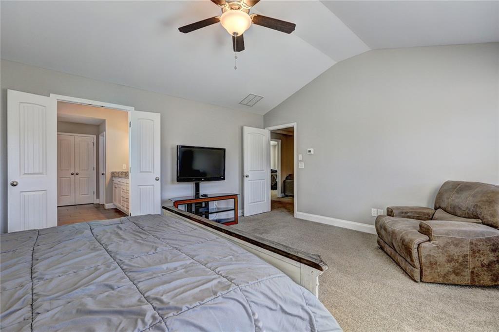 4371 Thacker Lane Suwanee, GA 30024 - Photo 26 of 52 a bedroom with a bed and a flat screen tv