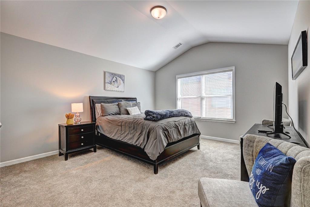 4371 Thacker Lane Suwanee, GA 30024 - Photo 35 of 52 a bedroom with a bed and a flat screen tv