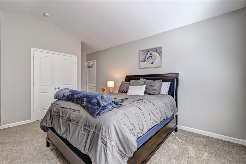 4371 Thacker Lane Suwanee, GA 30024 - Photo 37 of 52 a bedroom with a bed and painting on the wall