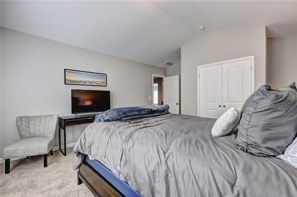 4371 Thacker Lane Suwanee, GA 30024 - Photo 38 of 52 a bedroom with a bed and a couch