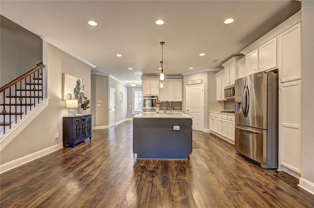4371 Thacker Lane Suwanee, GA 30024 - Photo 5 of 52 a kitchen with refrigerator cabinets and wooden floor