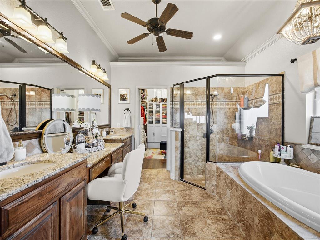 105 Mesquite Court Decatur, TX 76234 - Photo 16 of 36 Primary en-suite with dual sinks, granite counters, soaking tub and separate shower