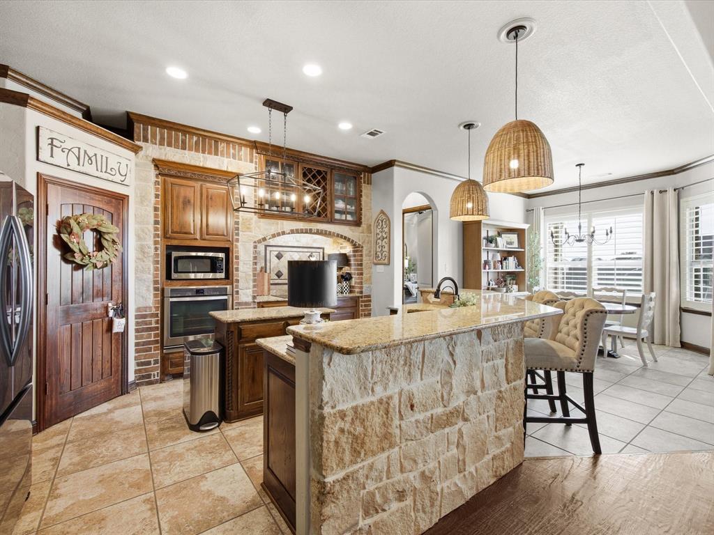 105 Mesquite Court Decatur, TX 76234 - Photo 8 of 36 Kitchen features granite counter tops, all electric appliances and ample cabinets for storage