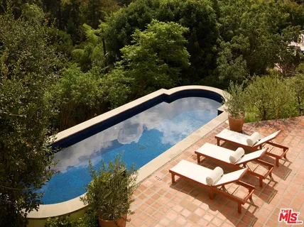 a view of a balcony with a yard