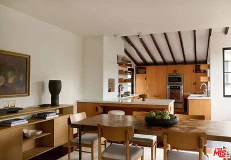 a kitchen with a table chairs and a stove
