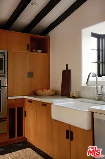 a table and chairs in a room next to a window