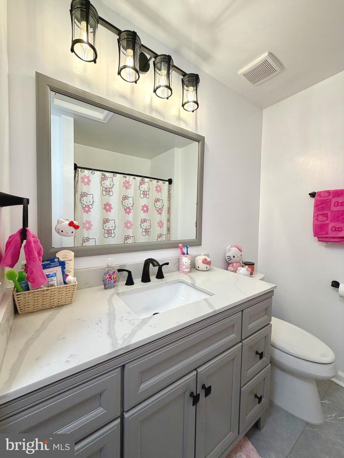 7108 Wheeling Way Gainesville, VA 20155 - Photo 31 of 45 a bathroom with a sink a toilet and a mirror