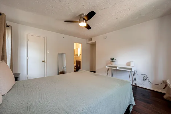 a bedroom with a bed and a table