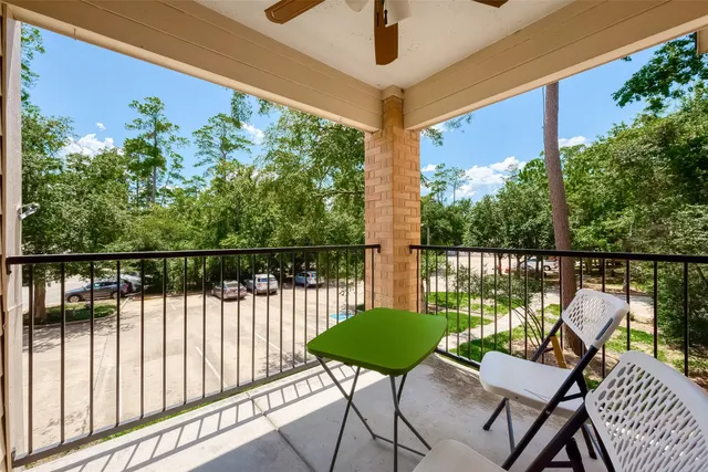 a view of a chairs and table in the balcony