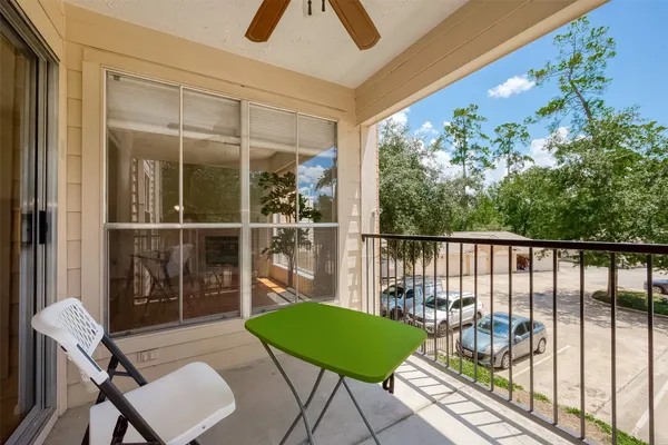 a view of a chairs and table in the balcony
