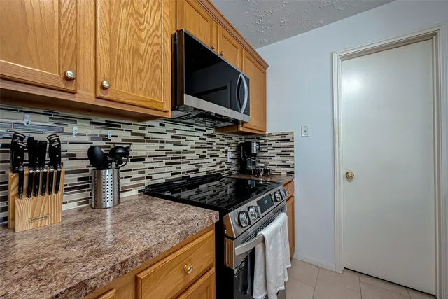 a kitchen with stainless steel appliances granite countertop a stove and a microwave