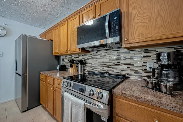 a kitchen with stainless steel appliances granite countertop a stove and a refrigerator