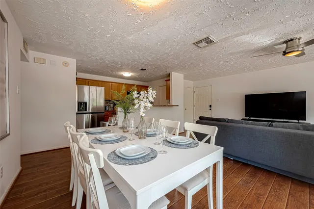 a kitchen with a sink and a stove top oven with wooden floor