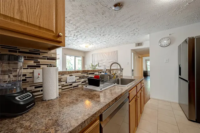 a kitchen with refrigerator and cabinets